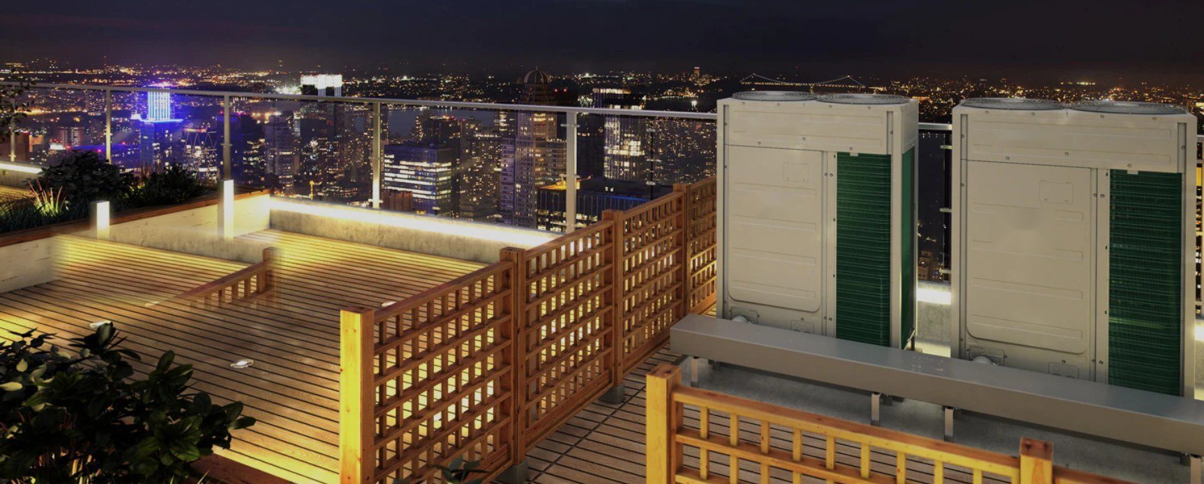 VRF outdoor units on a rooftop terrace overlooking the city at night